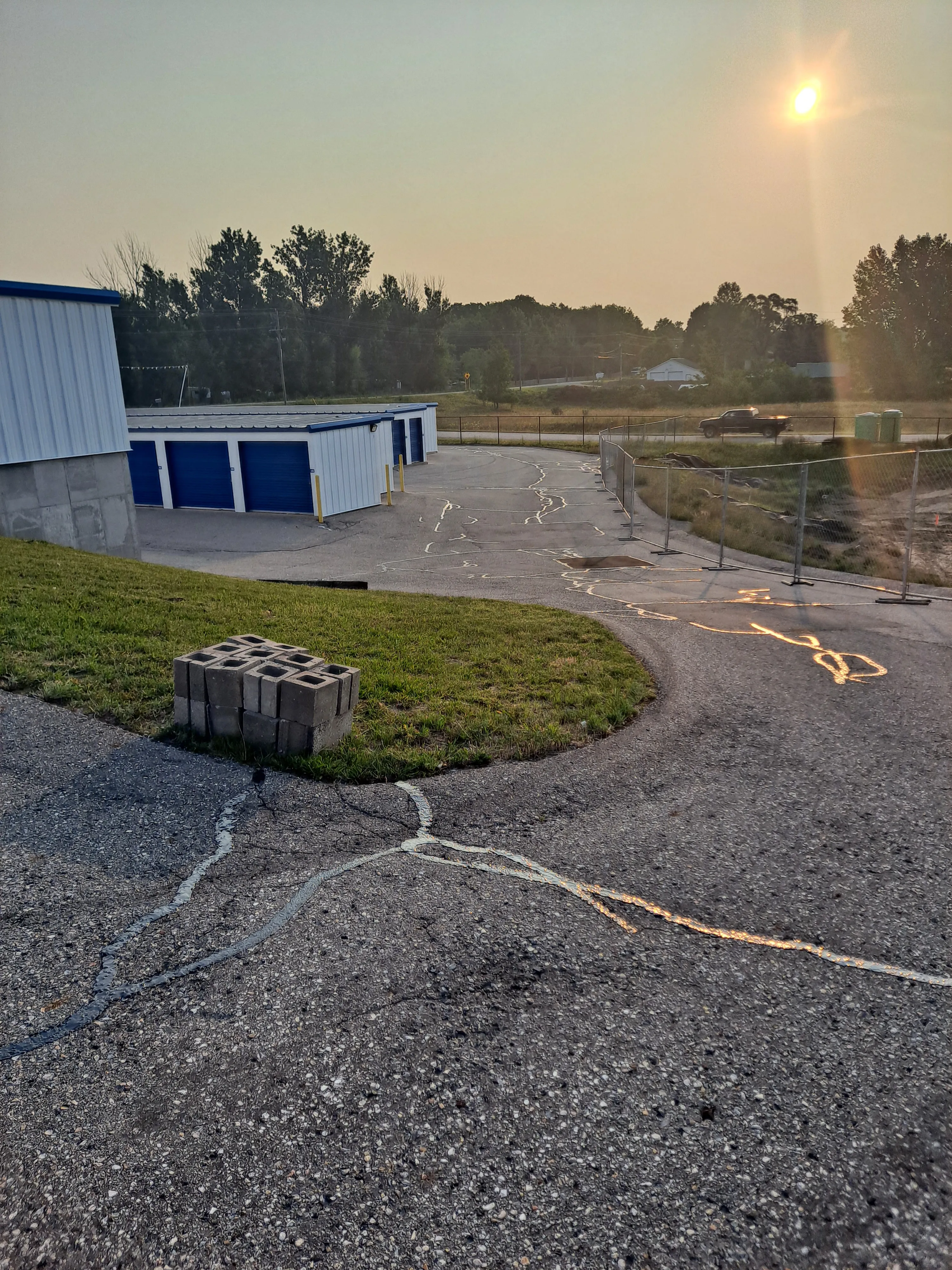 Parking lot with freshly filled cracks sealed with hot rubberized asphalt
