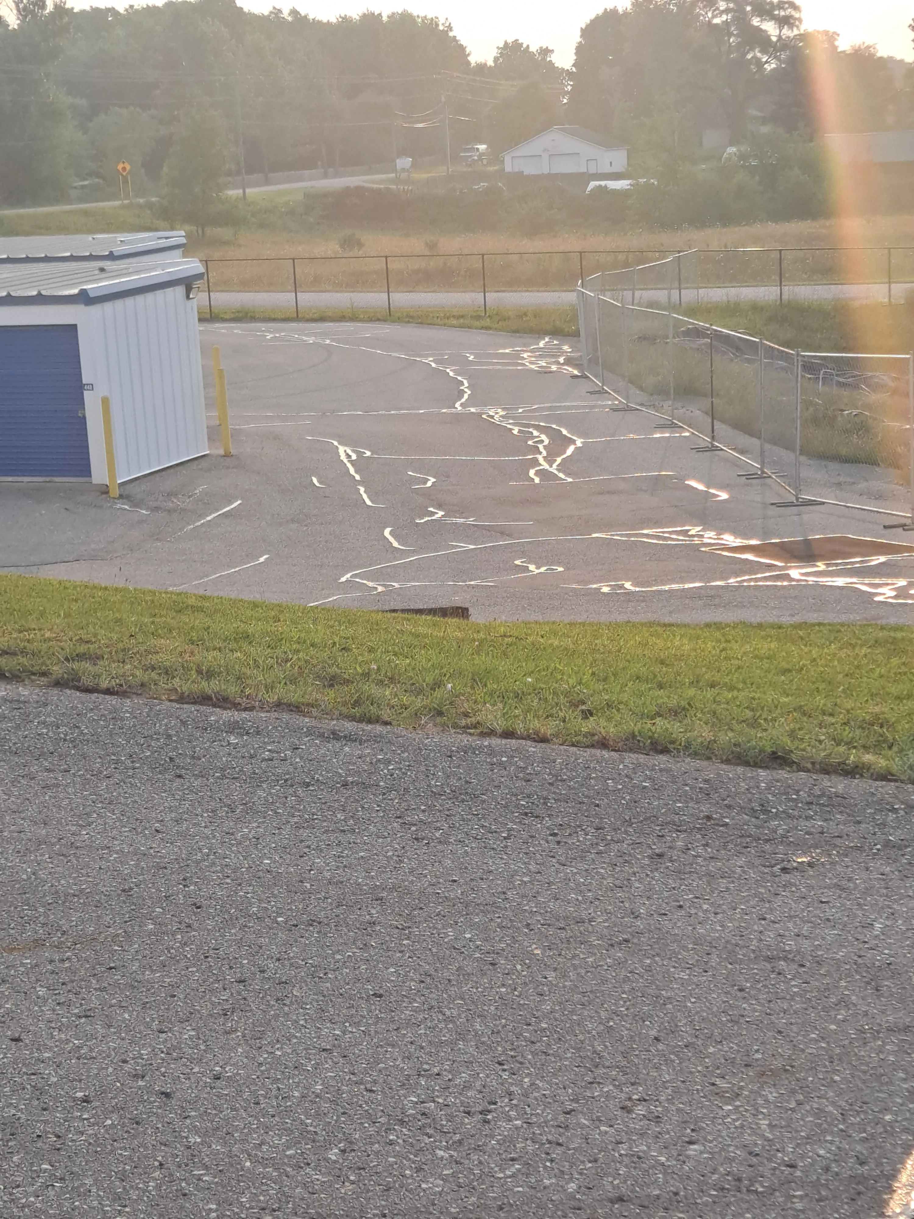 Commercial lot surface prepared with crack sealing around drainage areas
