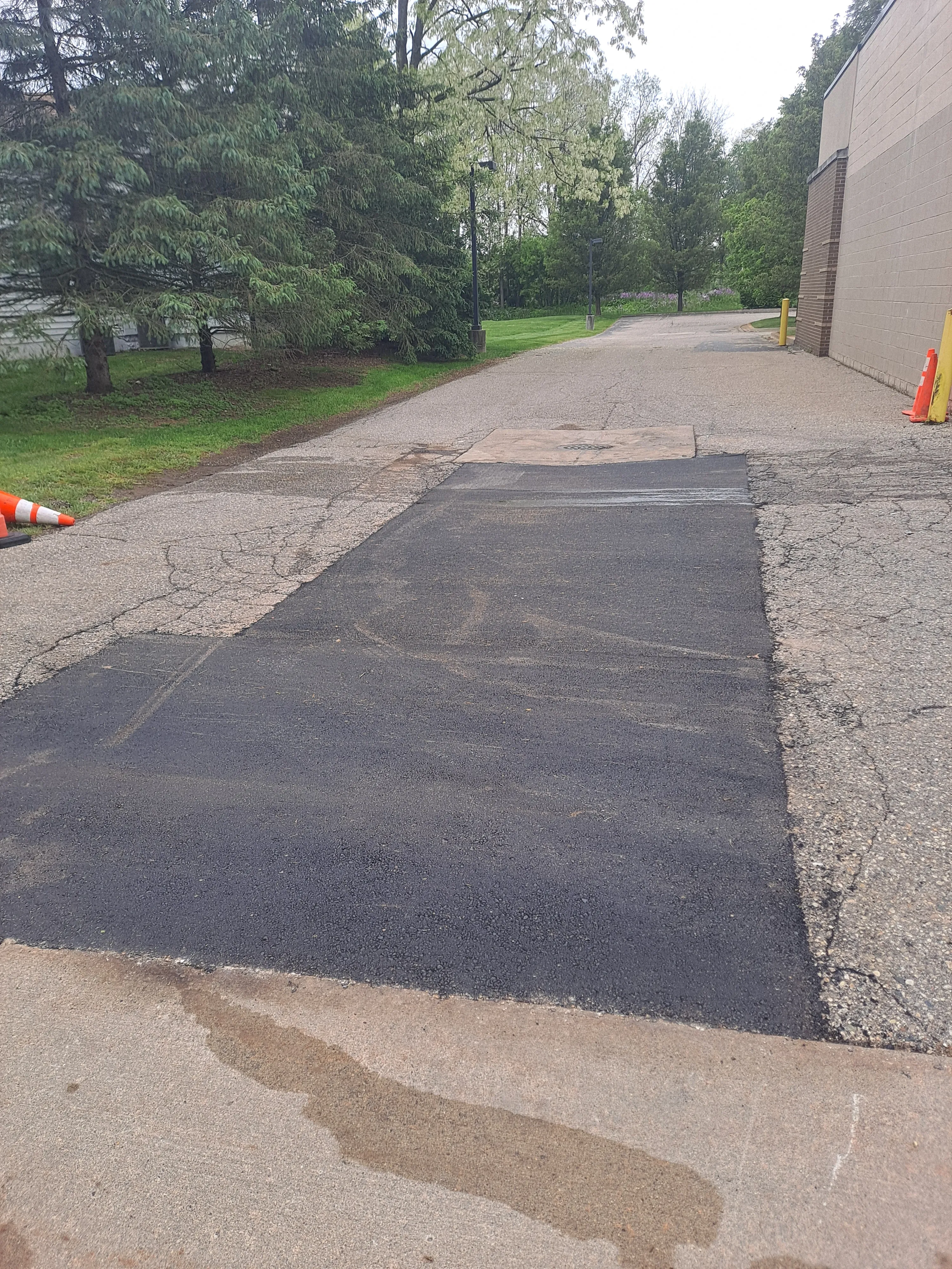 Smooth asphalt patch repair on a commercial drive lane