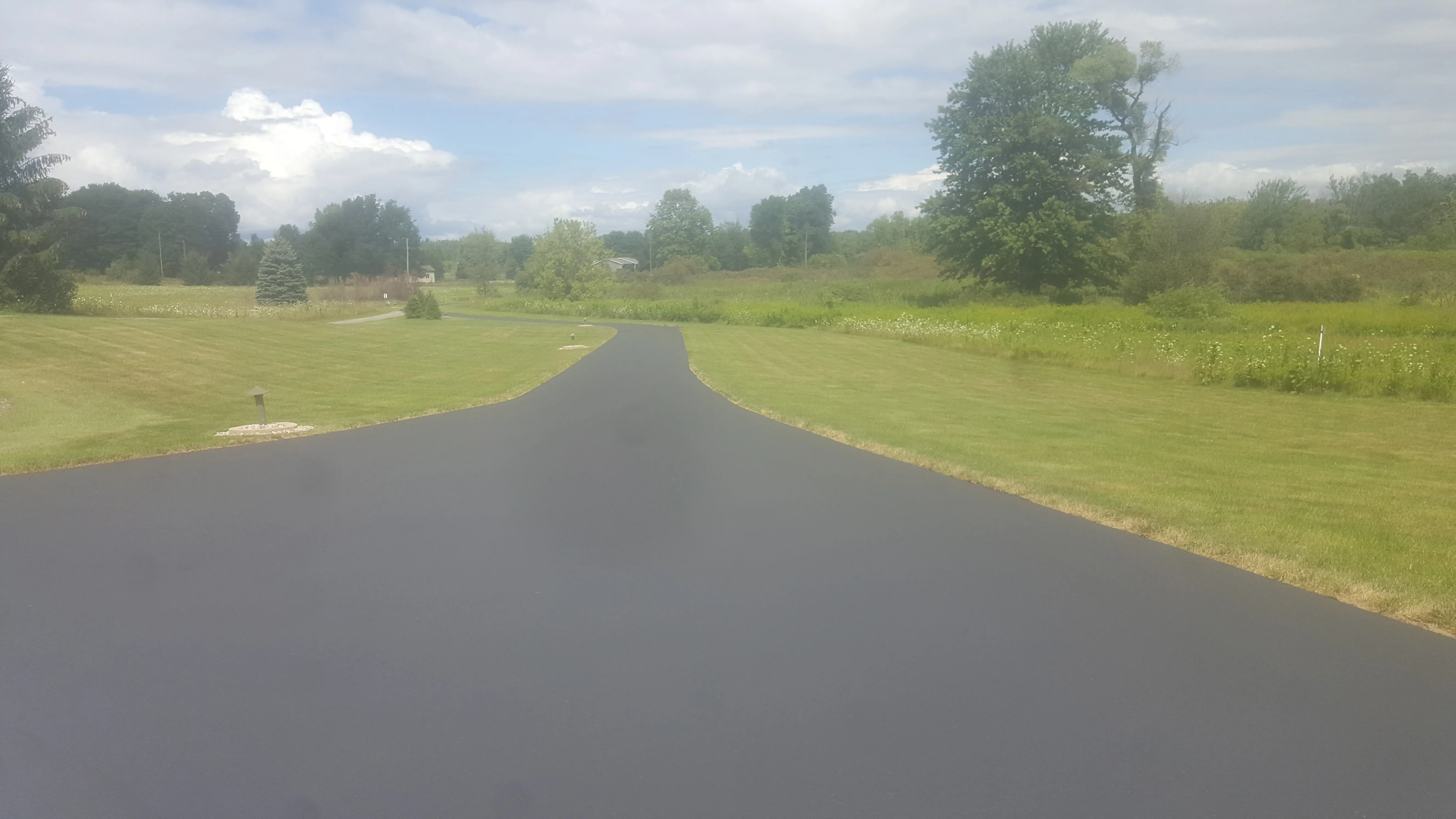 Freshly sealed and crack-filled residential driveway